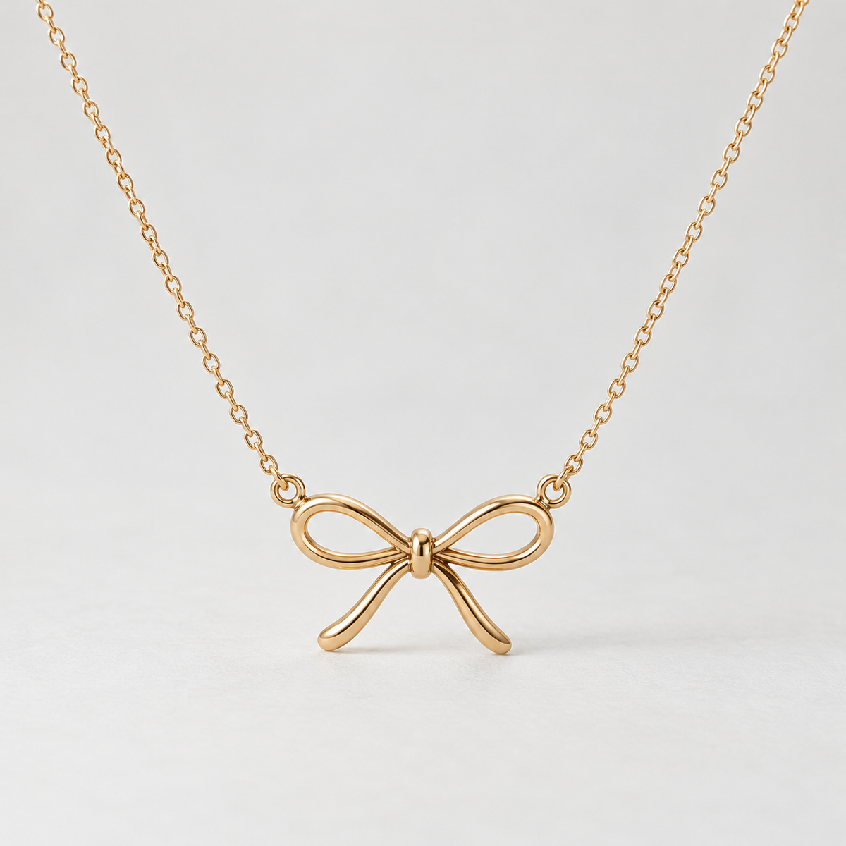 elvarinio Delicate Bow Necklace — studio design visualization [main]. AI-generated; product specifications pending verification.